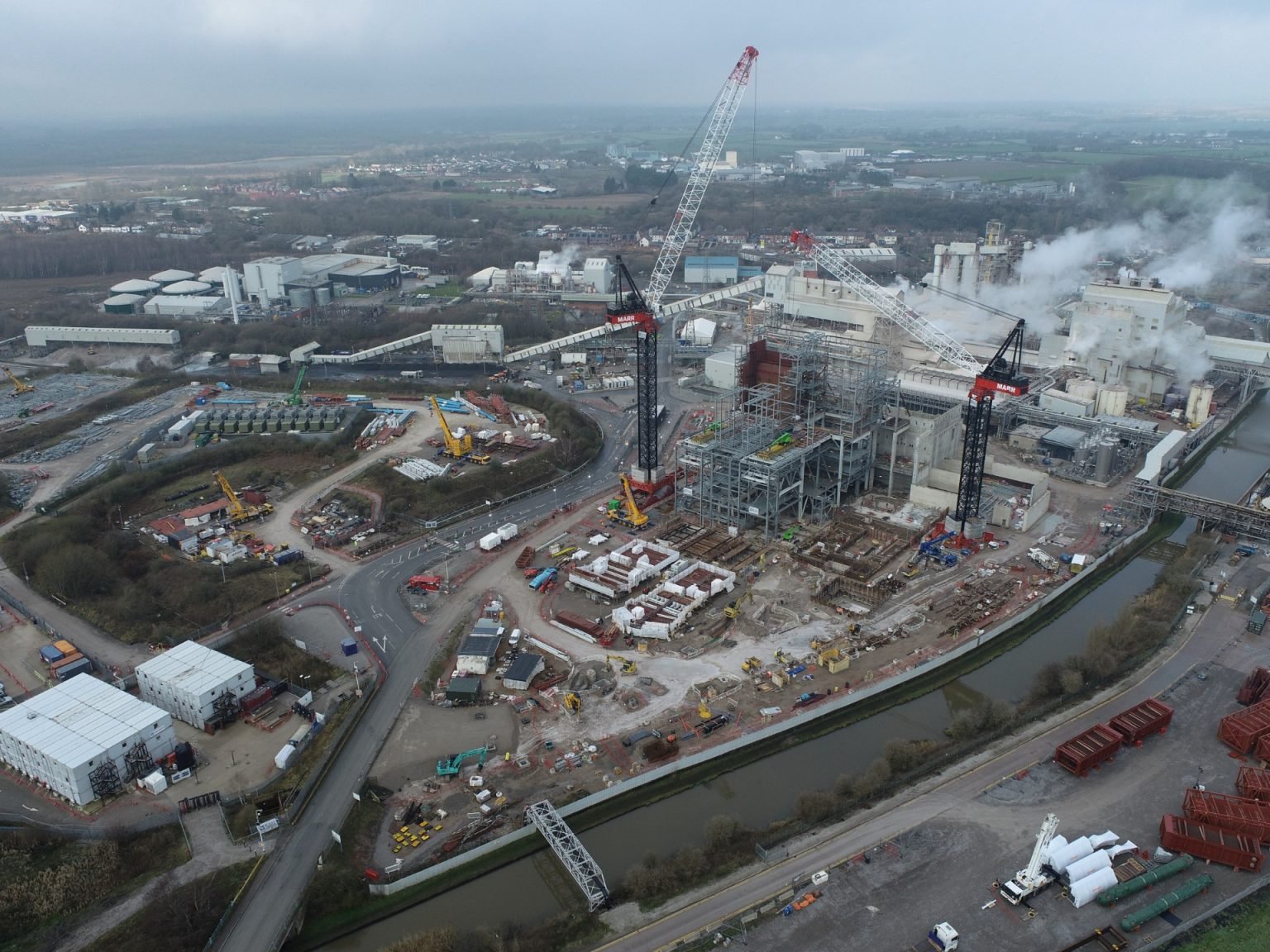 Aerial view of industrial construction site with cranes